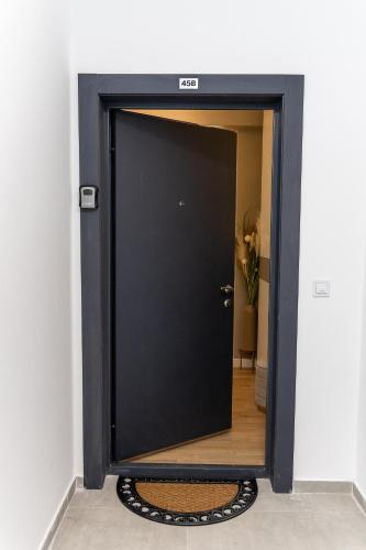 a black door in a room with a mirror at Kaltak Luxury Stay in Bar
