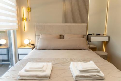 a bedroom with a bed with two towels on it at Kaltak Luxury Stay in Bar