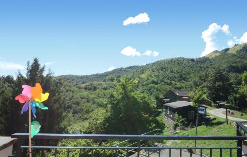 a colorful pinwheel on a balcony with a mountain at Gorgeous Apartment In Colli Di Ossegna With Wifi in Valletti