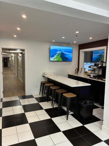 a kitchen with a black and white checkered floor at Mainstay Inn in Phoenixville