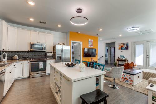 a kitchen with an island in the middle of a room at The Q - Austin Family Home - Hot Tub, Sauna & Golf Sim in Austin