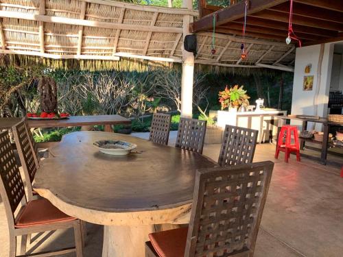 a wooden table and chairs on a patio at Palapa Ganesh in Sayulita