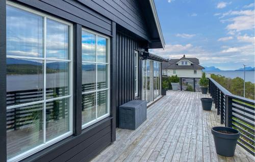 a house with a balcony with a view of the water at Stunning Home In Skåla With House A Panoramic View in Røvik
