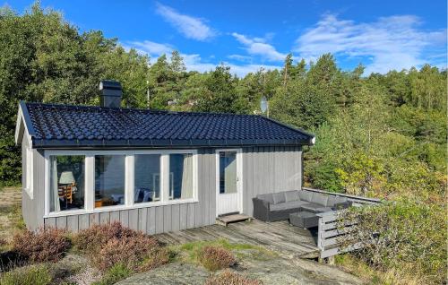 a small house on a deck with a view at Awesome Home In Kolbjørnsvik With House Sea View in Skarvedalen