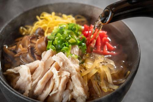a bowl of soup with meat and vegetables at Kirishima Kokusai Hotel in Kirishima
