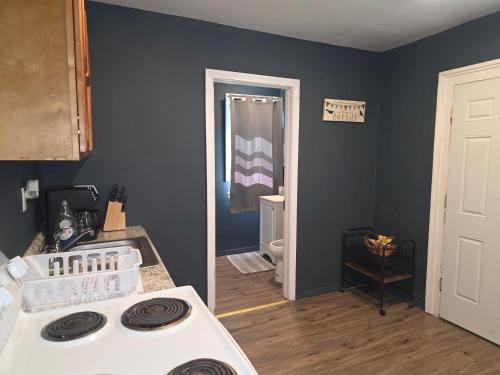 a kitchen with a white stove top oven in a room at Fashionably cozy2 in Meriden