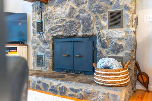 a blue door in a stone wall with a basket at Relaxing Lakefront Retreat w/ Hot Tub & Dock in Blountville