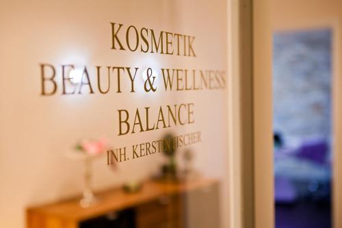 a sign on a wall in a room with a table at Thermalhotel Gass in Bad Füssing