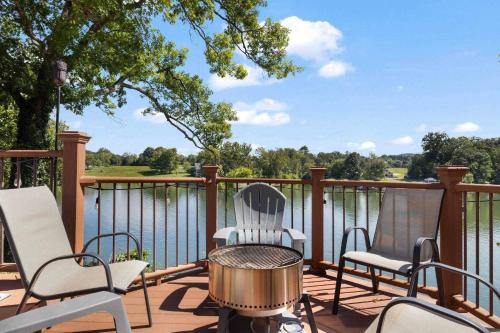 a patio with chairs and a table with a view of the water at Relaxing Lakefront Retreat w/ Hot Tub & Dock in Blountville