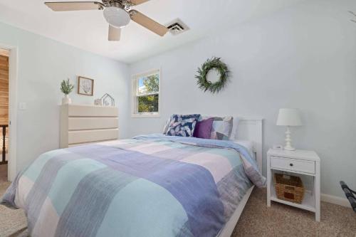 a bedroom with a bed and a ceiling fan at Relaxing Lakefront Retreat w/ Hot Tub & Dock in Blountville