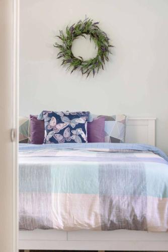 a bedroom with a bed with a wreath on the wall at Relaxing Lakefront Retreat w/ Hot Tub & Dock in Blountville