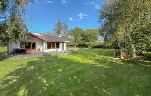 a house in a yard with a large green lawn at Stunning Home In Tarm With Sauna in Højsand