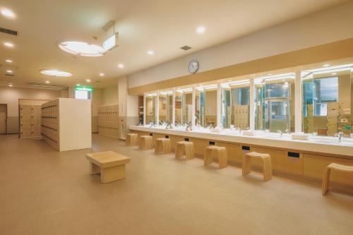 a large room with a row of tables and chairs at Oehonke in Kitami