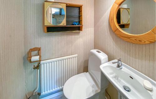 a bathroom with a toilet and a sink and a mirror at 1 Bedroom Amazing Home In Jät in Jät