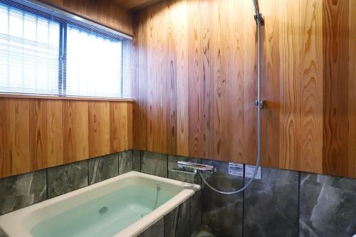 a bathroom with a bath tub and a shower at Potsupotsuan - Vacation STAY 20035 in Ise
