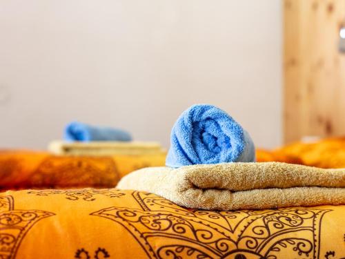 a pile of towels sitting on top of a couch at Schweizerhof Margrith in Huben