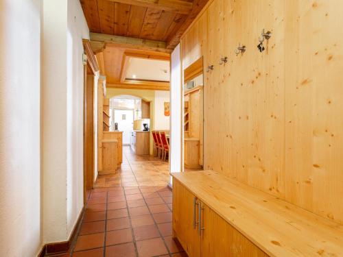 a hallway of a house with a wooden wall at Schweizerhof Margrith in Huben
