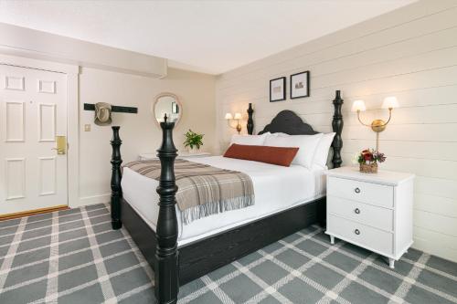 a bedroom with a large bed and a dresser at The Wentworth in Jackson