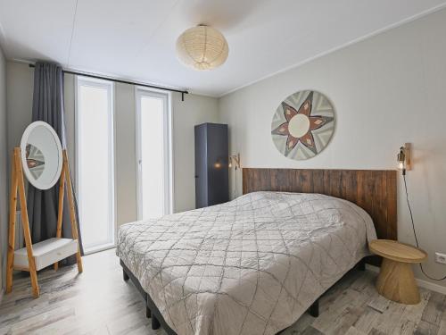 a bedroom with a bed and a large window at Casa Familia in Sint Annaland