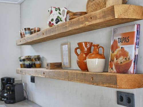 a couple of wooden shelves on a wall at Casa Familia in Sint Annaland