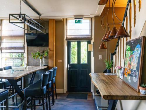 a dining room with a table and chairs and a door at Billie in Weerselo