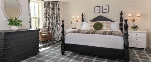 a bedroom with a bed and a dresser and a mirror at The Wentworth in Jackson