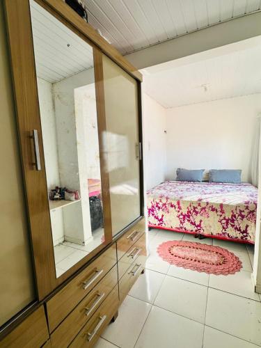a small bedroom with a bed and a mirror at COP 30 Apartamento próximo do Hangar in Belém