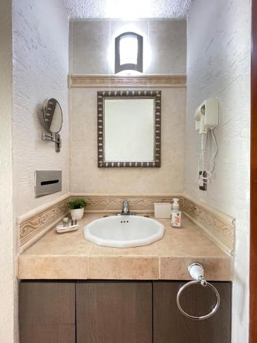 a bathroom with a sink and a mirror at Incredible Suite Cancun - BEACH CONDO - 6PX in Cancún