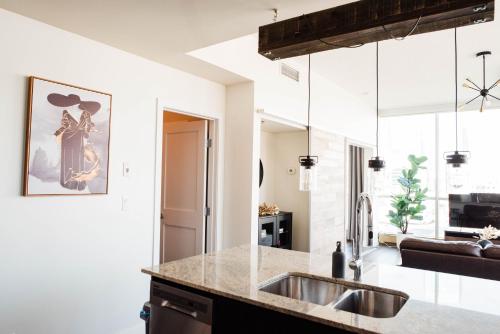 a kitchen with a sink and a counter at City Views Walk to Calgary Tower and Stampede in Calgary