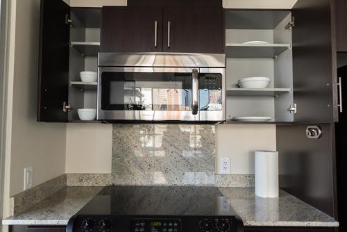 a kitchen with a microwave and a counter top at City Views Walk to Calgary Tower and Stampede in Calgary