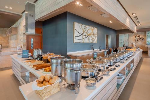 a buffet line with food on display in a restaurant at Holiday Inn Acapulco La Isla by IHG in Acapulco