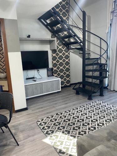 a living room with a spiral staircase and a wine cellar at Saint Sebastian Flat 613 - Com Hidro! Até 3 pessoas, Duplex, no Centro in Jaraguá do Sul