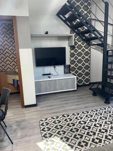 a living room with a flat screen tv on a wall at Saint Sebastian Flat 613 - Com Hidro! Até 3 pessoas, Duplex, no Centro in Jaraguá do Sul