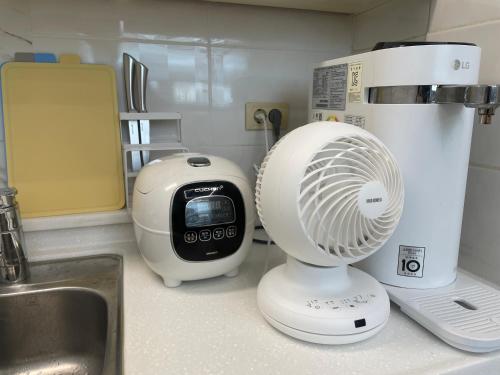 a kitchen counter with a fan and a mixer at 복층 오피스텔 in Tujŏng-dong