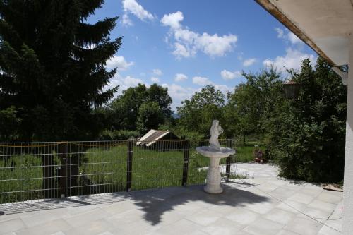 a stone statue sitting in front of a fence at Pension Griebel in Buoch