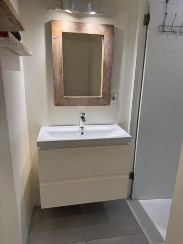 a bathroom with a sink and a mirror at Boutique Hotel & apartments JT Curaçao in Willemstad