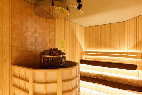a sauna with a bowl of grapes in a room at Oehonke in Kitami