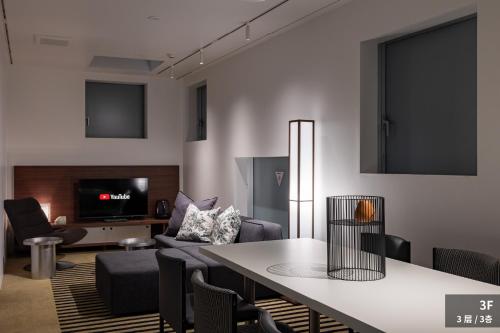 a living room with a table and a couch at JAPAVISTA r4 in Tokyo
