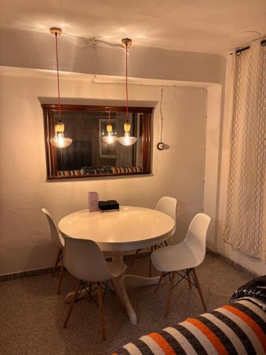 a dining room table with chairs and a mirror at Piso en el corazón de Alcañiz in Alcañiz