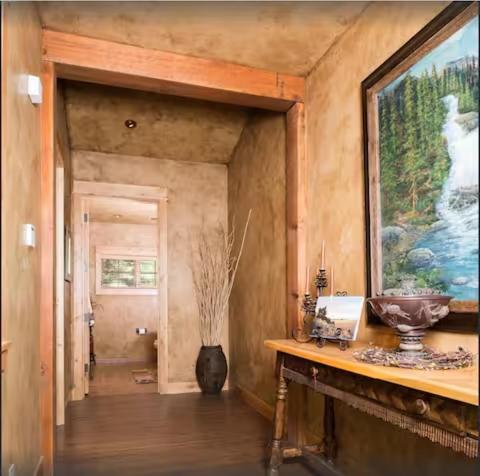 a hallway of a house with a vase on a table at Luxury Home with Stunning 4 Peak Views in Tetonia