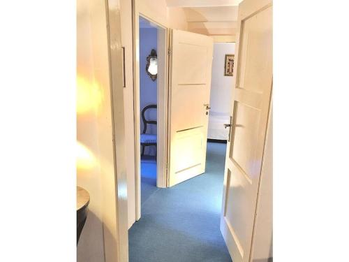 a hallway with two open doors and a room at Holiday home with 4 bedrooms in Maroldsweisach