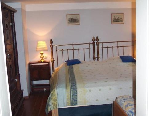 a bedroom with a bed and a lamp and a table at Holiday home with 4 bedrooms in Maroldsweisach