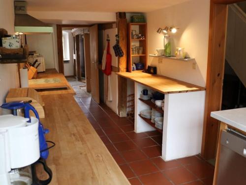 a kitchen with a counter and a tile floor at Holiday home with 4 bedrooms in Maroldsweisach