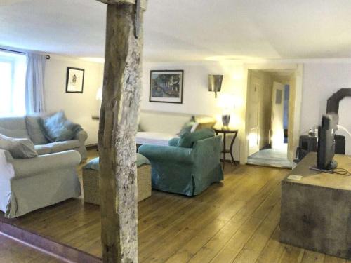 a living room with two couches and a living room with at Holiday home with 4 bedrooms in Maroldsweisach