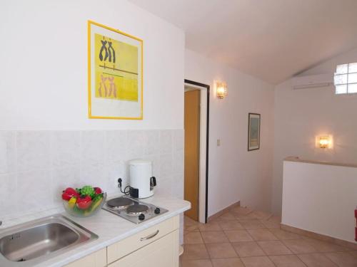 a kitchen with a sink and a counter top at Holiday apartment in Porec with swimming pool in Poreč