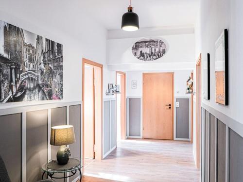 a hallway with a door and a table with a lamp at Holiday apartment with 4 bedrooms in Eisenach