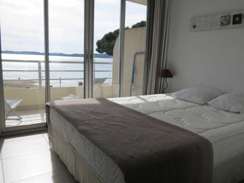 a bedroom with a bed and a large window at Apartment Splendid Azur in Sainte-Maxime
