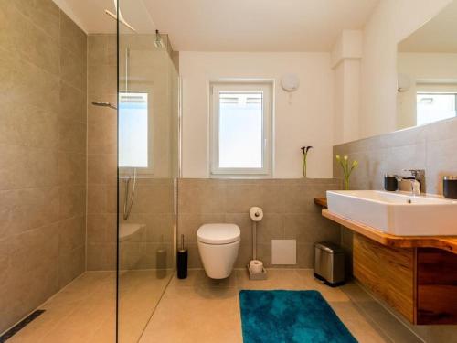ein Badezimmer mit Waschbecken, Toilette und Dusche in der Unterkunft Holiday apartment with 2 bedrooms in Kalzhofen