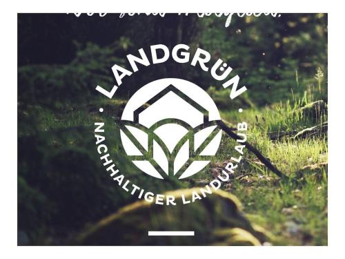 a logo for a wilderness lodge with a symbol at Castle Apartment "Cook" in Maroldsweisach