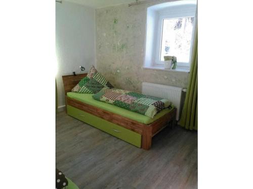 a small bed in a room with a window at One-bedroom apartment in Cobbenrode